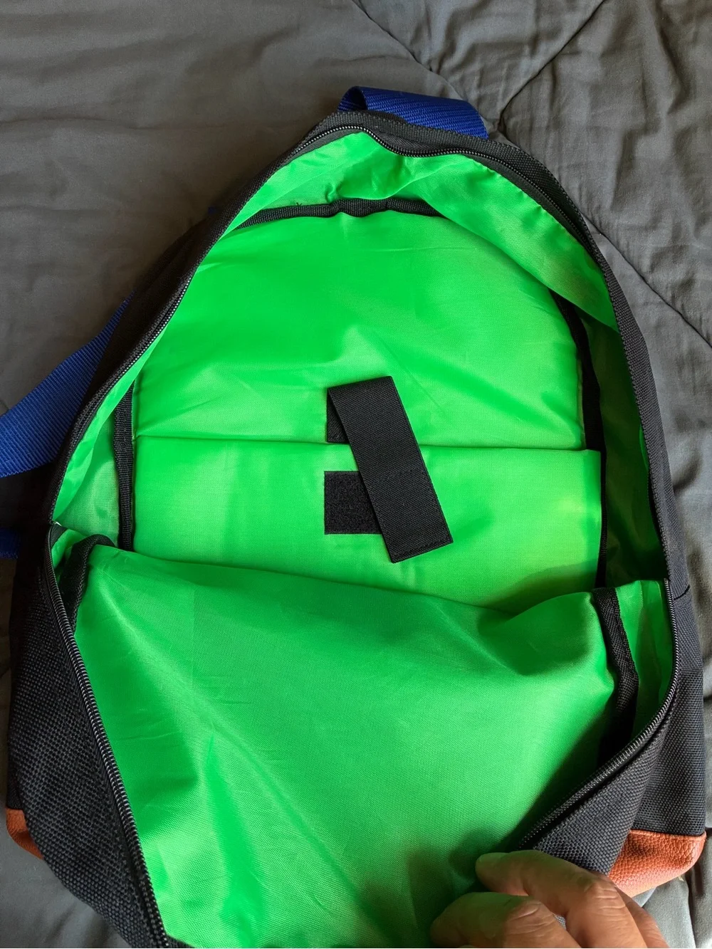 Black Backpack with Orange Trim and Blue Strap